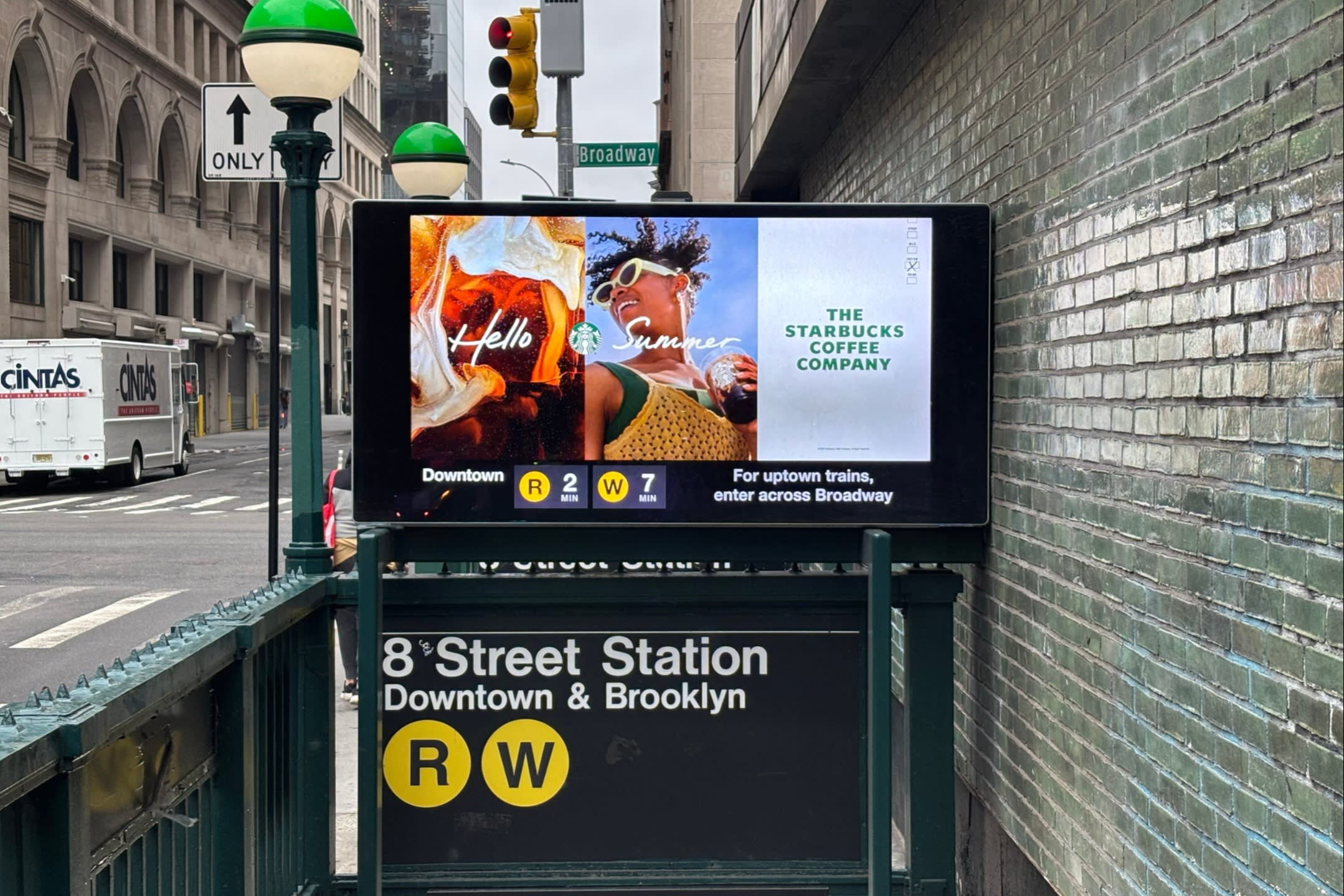 A video advertising Starbucks above the 8th Street subway entrance