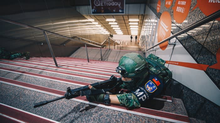 A Taiwan military police soldier takes party in drills in a metro station in Taipei