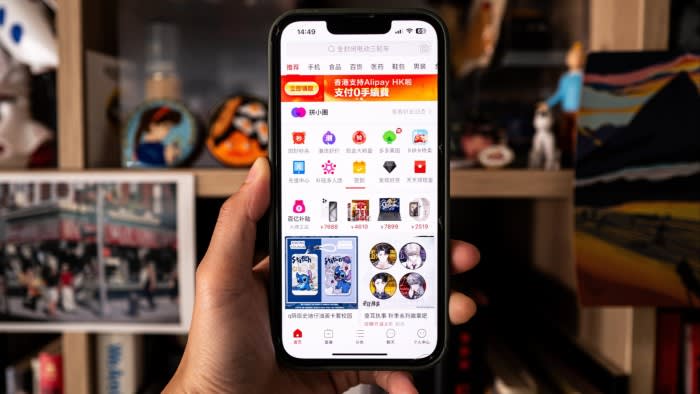 A smartphone user looks at the Temu app