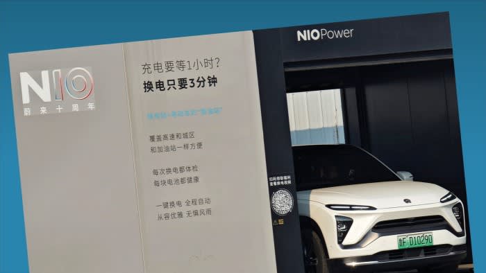 A NIO electric car gets its battery swapped at a NIO Power battery swap station
