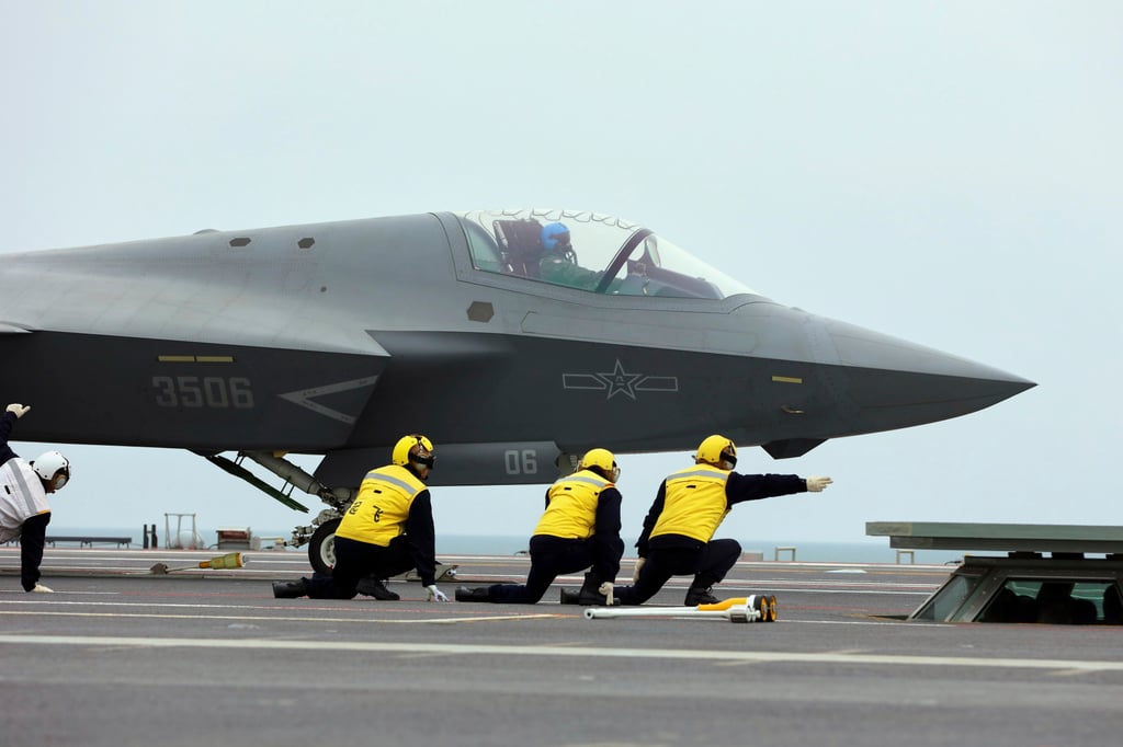 In another undated photo released on Tuesday by Xinhua, crew members signal to the pilot of a J-35 stealth fighter jet for a take-off on the flight deck of the Fujian at an undisclosed location. Photo: Xinhua via AP In another undated photo released on Tuesday by Xinhua, crew members signal to the pilot of a J-35 stealth fighter jet for a take-off on the flight deck of the Fujian at an undisclosed location. Photo: Xinhua via AP
