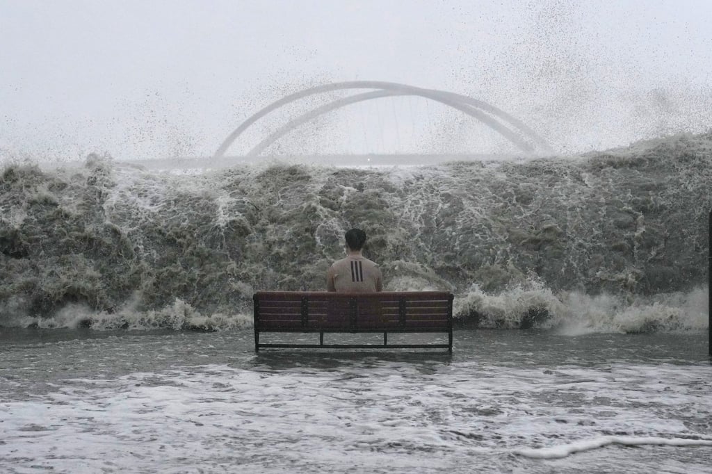A man sits on a bench on the Tseung Kwan O promenade as the waves approach. Photo: Elson Li