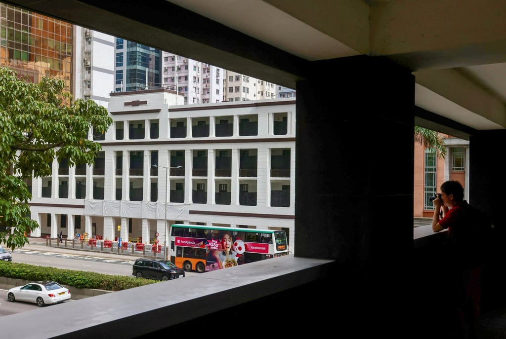 A pedestrian takes a picture of what will be the International Organisation for Mediation’s Hong Kong headquarters, at the site of the old Wan Chai Police Station, on June 1. Photo: Jonathan Wong