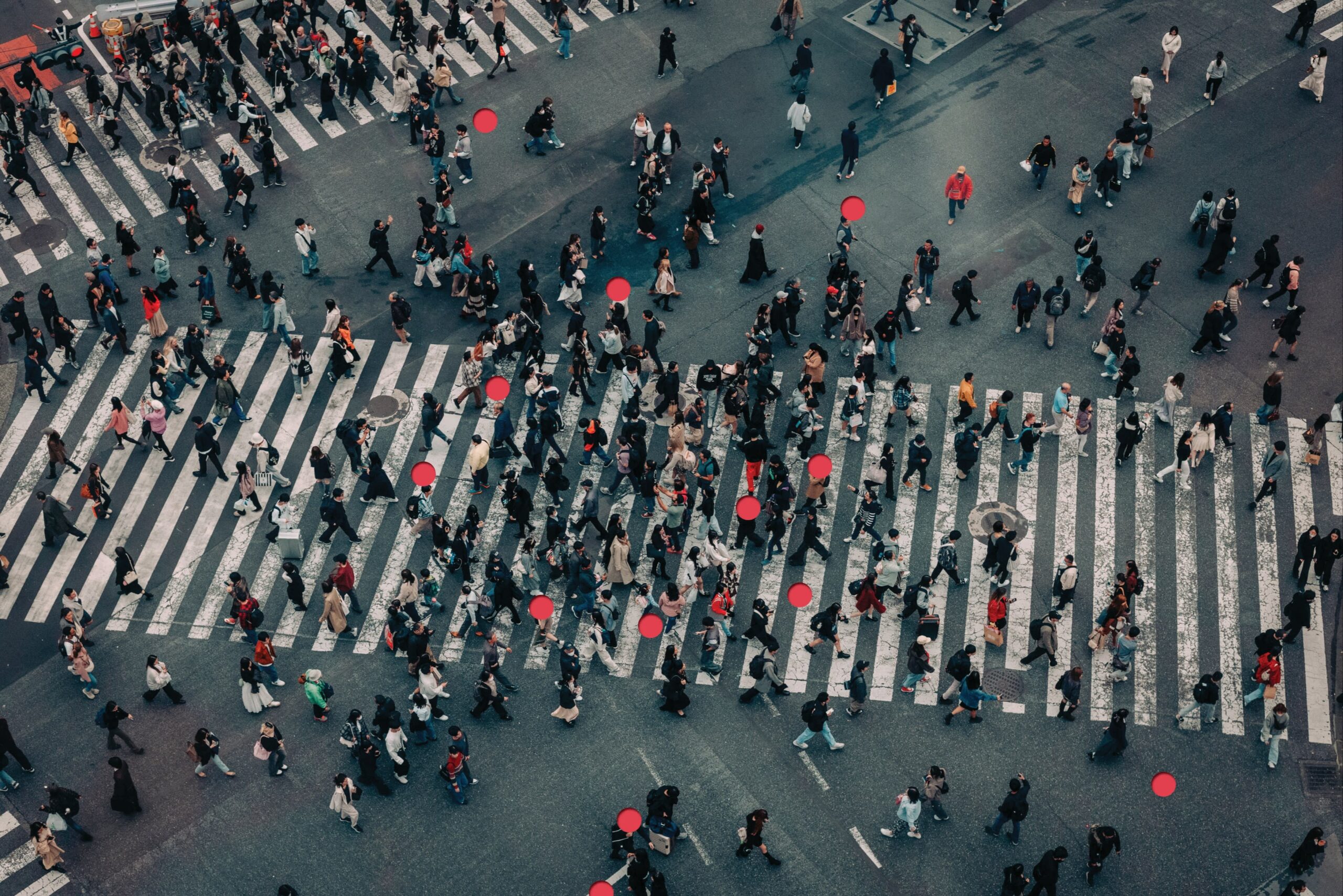 Aerial photo of a crosswalk crowded with people, highlighting certain individuals