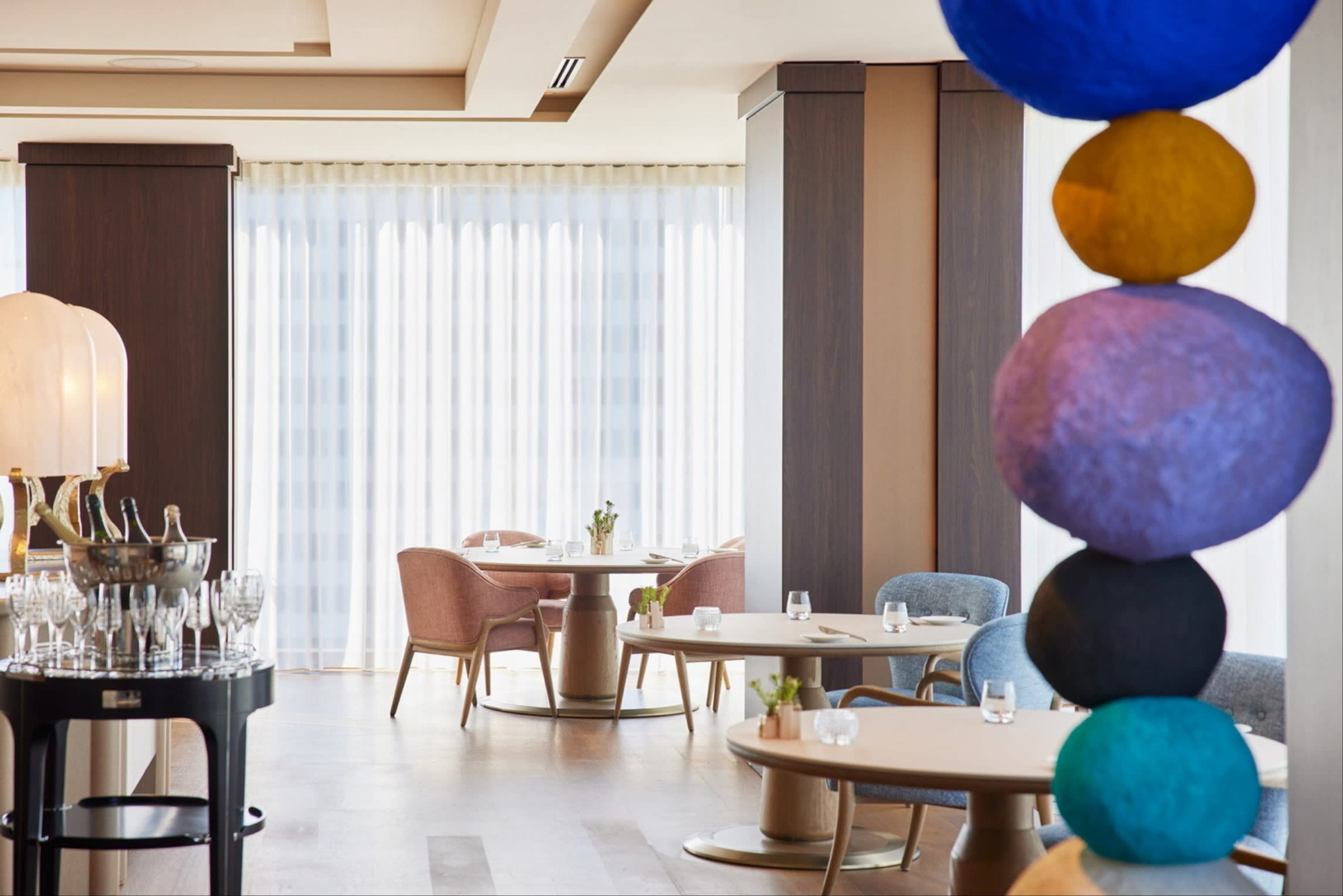 Detail of the interior of Sézanne, with an installation of blue, brown and black stones balanced on top of each other in the foreground.