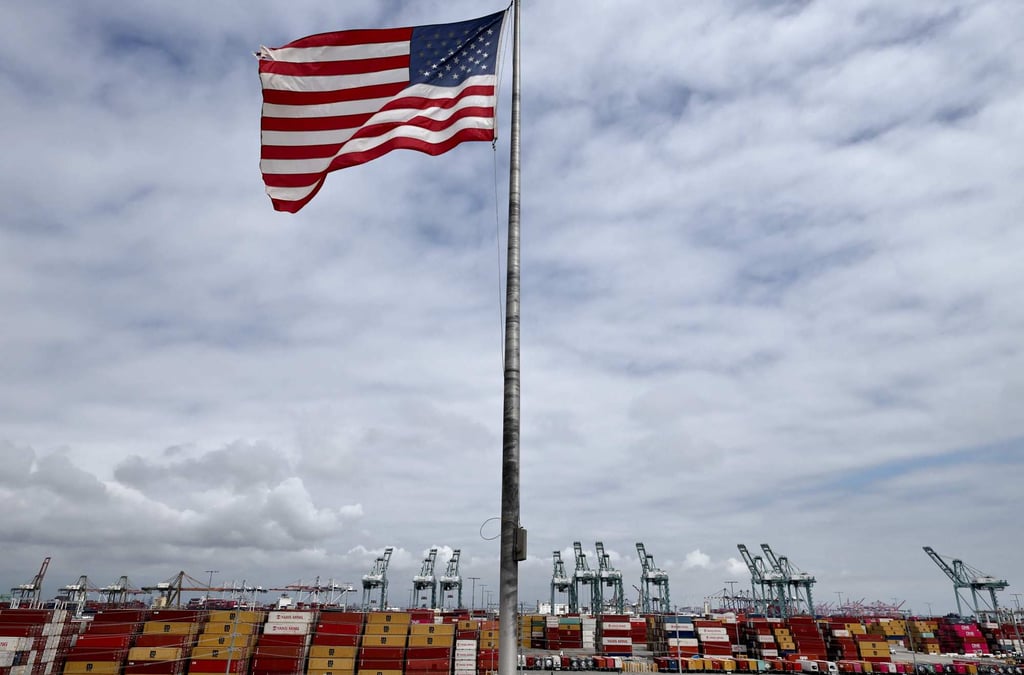 An American flag flies in front of shipping containers and cranes at the Port of Los Angeles last week in the California city. Photo: AFP