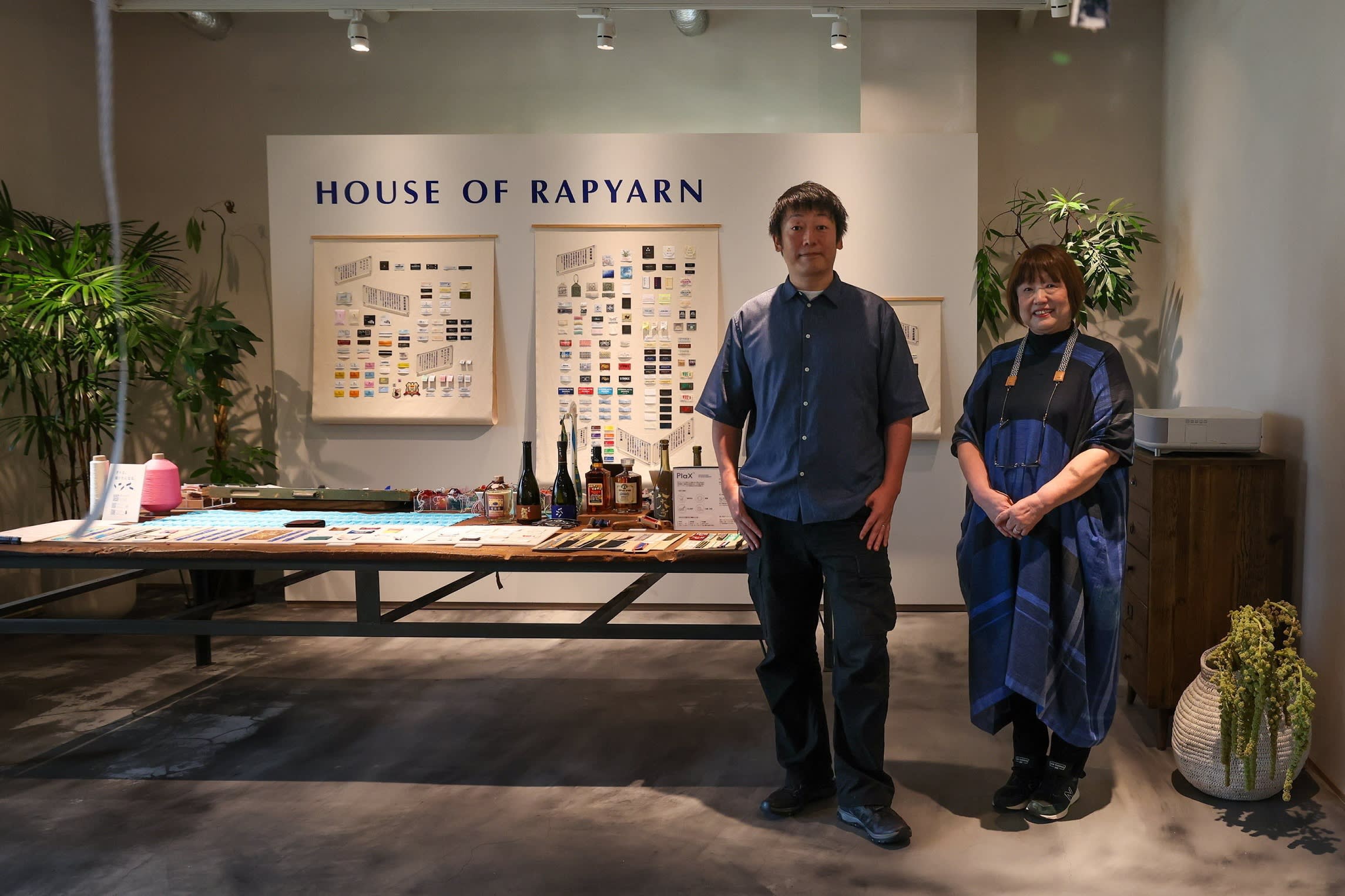 Akihisa Matsukawa and Hiromi Matsukawa stand together in front of a display