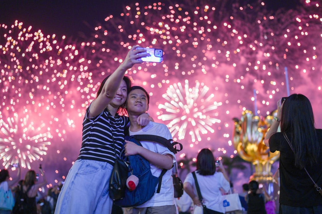 Revellers pose for a selfie during the fireworks display on National Day. Photo: Eugene Lee Revellers pose for a selfie during the fireworks display on National Day. Photo: Eugene Lee