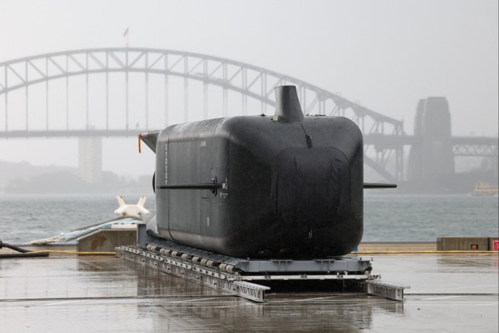 Anduril Ghost Shark XL-AUV sits on a dock at HMAS Kuttabul naval base, with Sydney Harbour Bridge visible in the background
