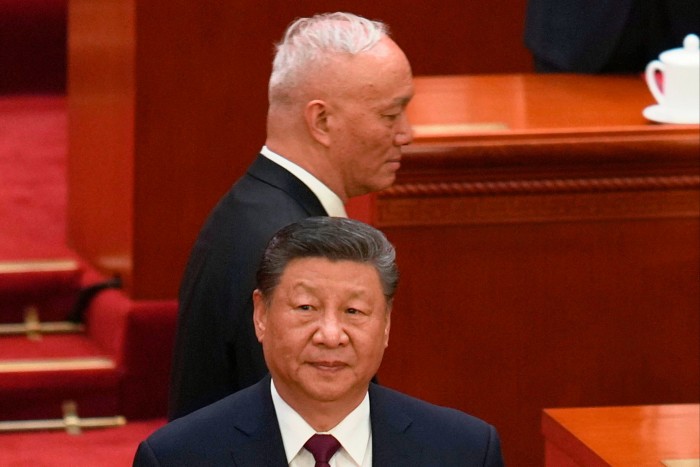 Cai Qi walks past Xi Jinping as they arrive for the closing ceremony of the National People's Congress in Beijing.