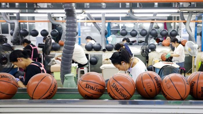Staff work on basketballs for export orders at a factory in the Sihong Economic Development Zone on September 12 2025 in Suqian, Jiangsu Province of China