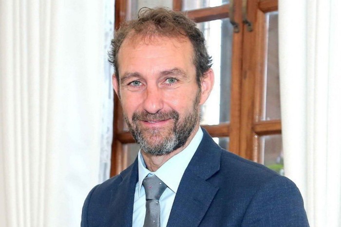 Matthew Collins, the UK’s deputy national security adviser, wearing a blue suit and tie.