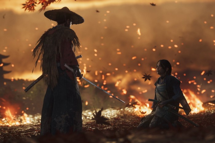 Two armoured characters face each other amid falling leaves and embers, with flames and smoke in the background. One stands holding a sword, while the other kneels, gripping their own weapon.