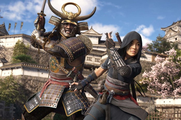 Outside a Japanese castle, a character in ornate samurai armour wields a sword, seemingly about to strike another character in a hooded assassin outfit.
