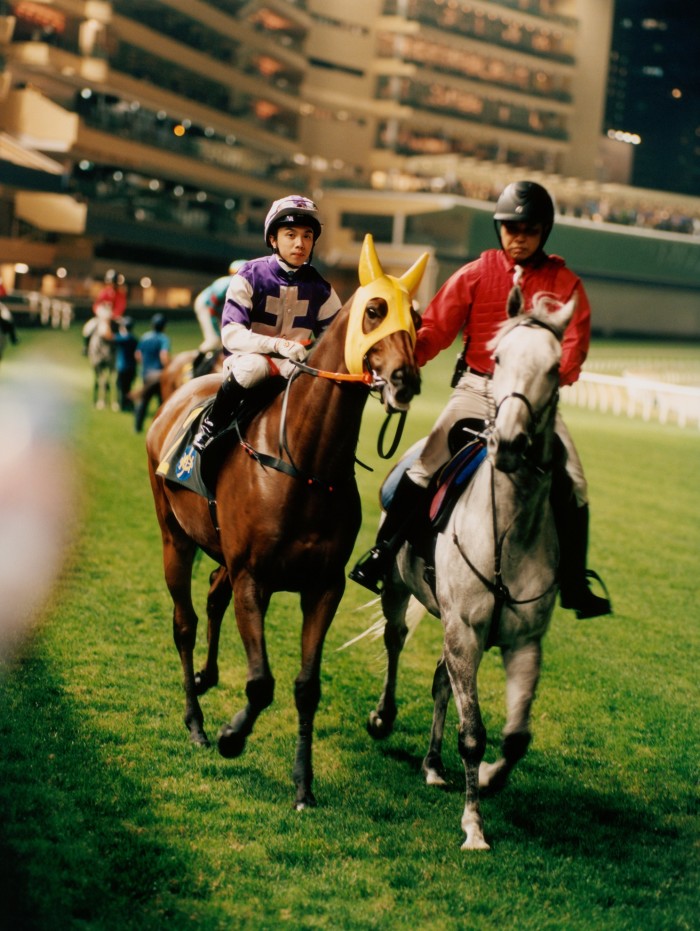 Mounted jockeys at the Happy Valley racecourse