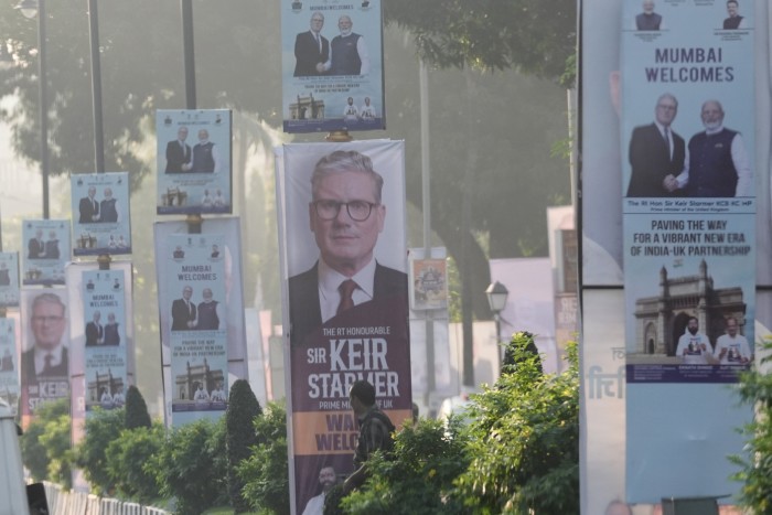Posters featuring Sir Keir Starmer, including one with Narendra Modi, line a street in Mumbai welcoming the UK Prime Minister.