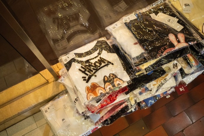 A pile of T-shirts wrapped in plastic.