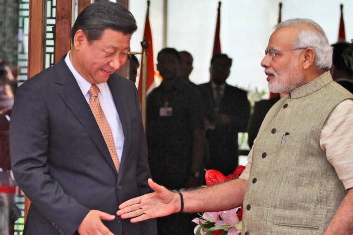 Indian Prime Minister Narendra Modi welcomes Chinese President Xi Jinping upon the latter’s arrival at a hotel in Ahmadabad, India