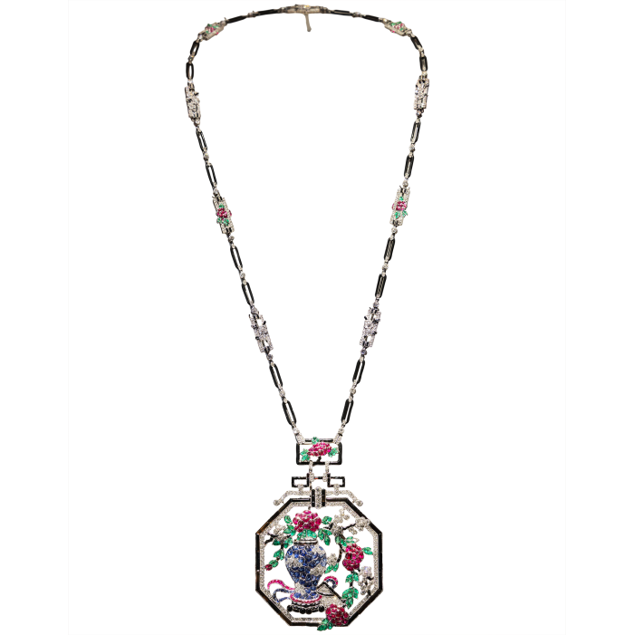 A jewelled pendant necklace featuring a vase and floral motif in coloured gemstones.