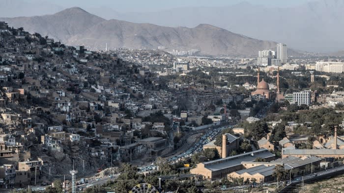 A view of the city of Kabul with mountains in the background.