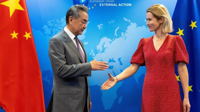 Kaja Kallas, vice-president of the European Commission, right, shakes hands with Wang Yi, China’s foreign minister
