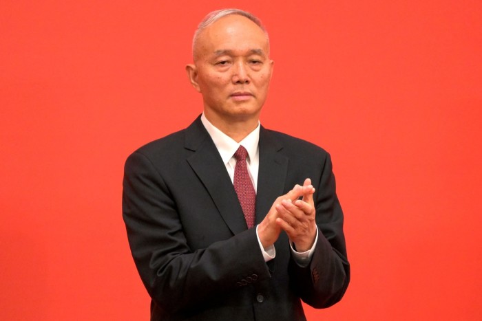 Cai Qi applauds while being introduced as a member of the Communist Party of China's Politburo Standing Committee.