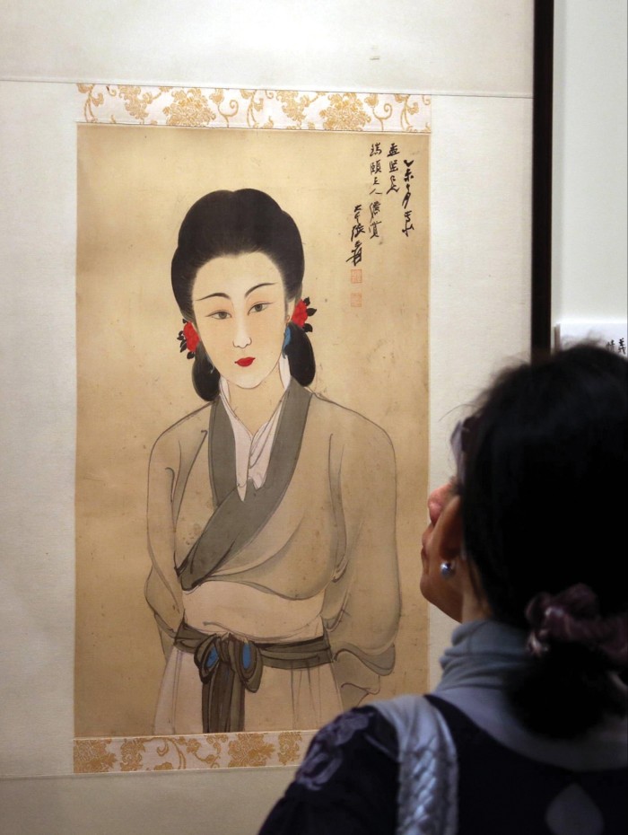 A visitor views a painting by Zhang Daqian at a Sotheby’s Autumn Sales 2012 preview in Hong Kong.