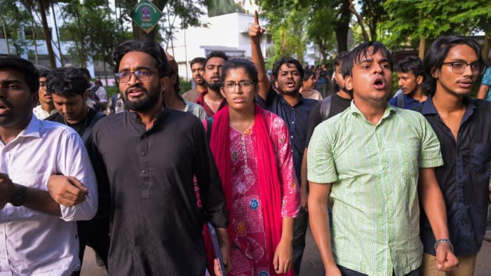 Umama Fatema marches with a group of students during the DUCSU elections, looking determined among others chanting.