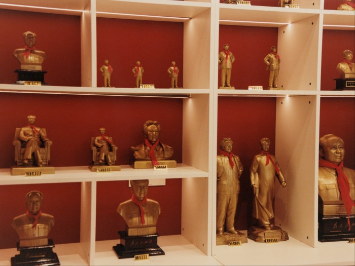 Shelves of gold-coloured busts and statuettes of Chairman Mao.
