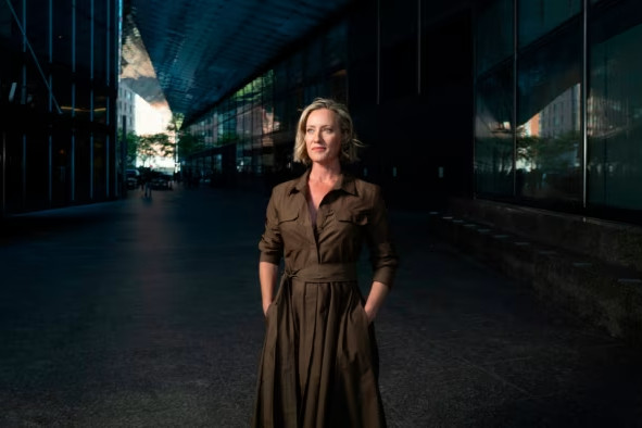 Ann Hiatt, who was chief of staff to former Google chief Eric Schmidt, stands with hands in pockets, wearing a brown dress, on a street in Manhattan