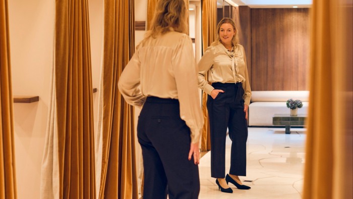 Claer Barrett trying on trousers