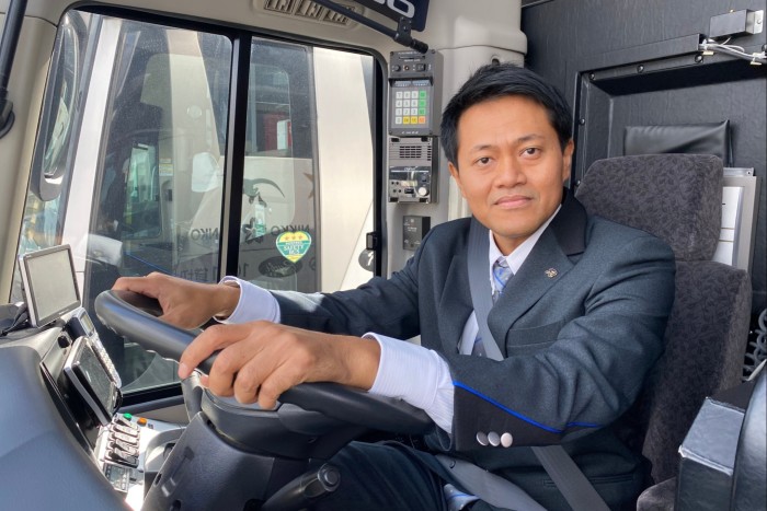 Nikko Kanko Bus driver Iyus in the driver’s cab of a tour bus