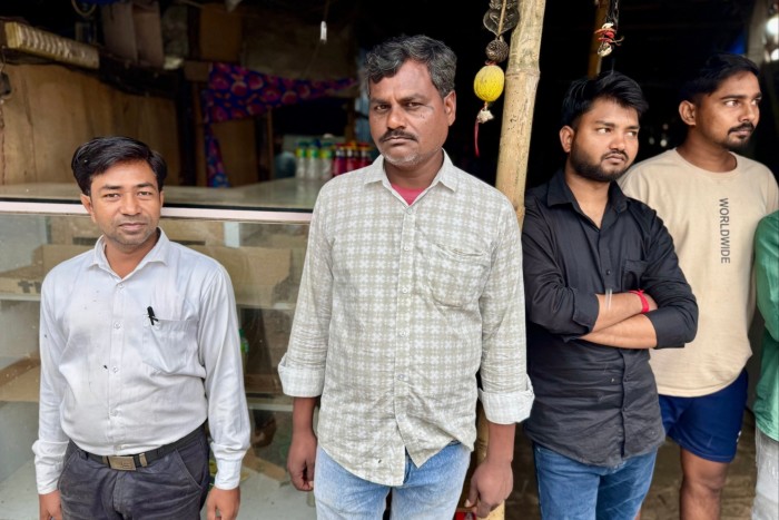 Dhiraj Kumar Sahni flanked by three other men.