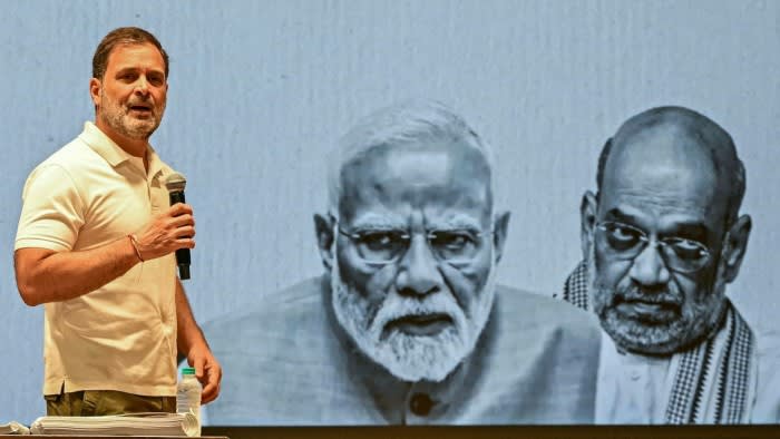 Indian National Congress party leader Rahul Gandhi, left, addresses the media in front of a screen showing India’s Prime Minister Narendra Modi, centre, and Home Minister Amit Shah at the party headquarters in New Delhi.