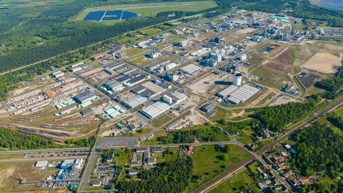 Aerial view of the Ineos industrial complex in Schwarzheide, Germany, showing large factory buildings, storage tanks and rail lines