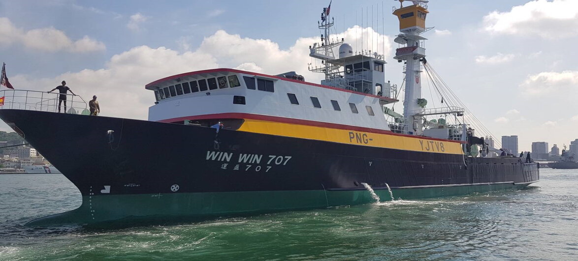 Alt text for image 2: Bunanda sits wrapped in a blanket looking unwell, while another man helps him drink from a cup.