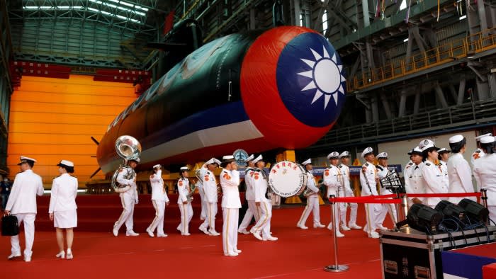 A Taiwanese naval band walks in front of Taiwan’s first domestically built submarine, at its launch ceremony in Kaohsiung in September