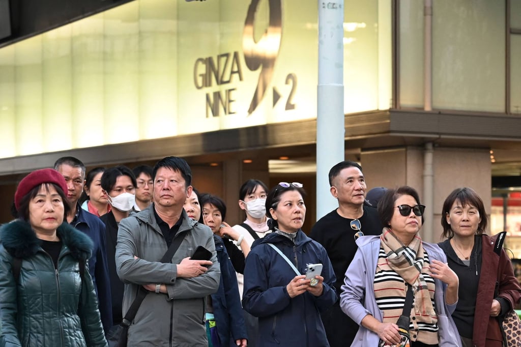 Members of a Chinese tour group wait to cross a road in Tokyo’s Ginza shopping district. Photo: AFP Members of a Chinese tour group wait to cross a road in Tokyo’s Ginza shopping district. Photo: AFP