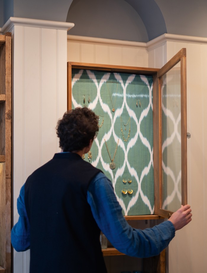 A display cabinet of jewellery in an alcove