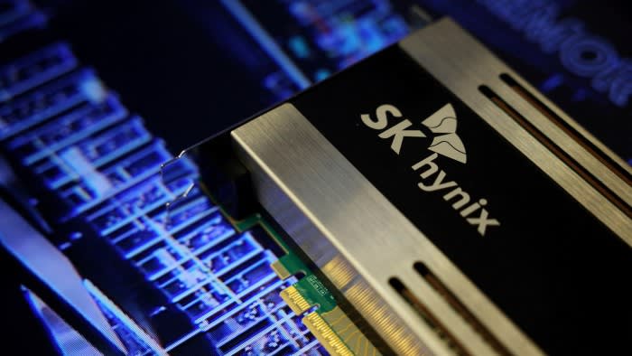 Close-up of an SK Hynix semiconductor product with the company logo visible, displayed against a blue circuit board background.