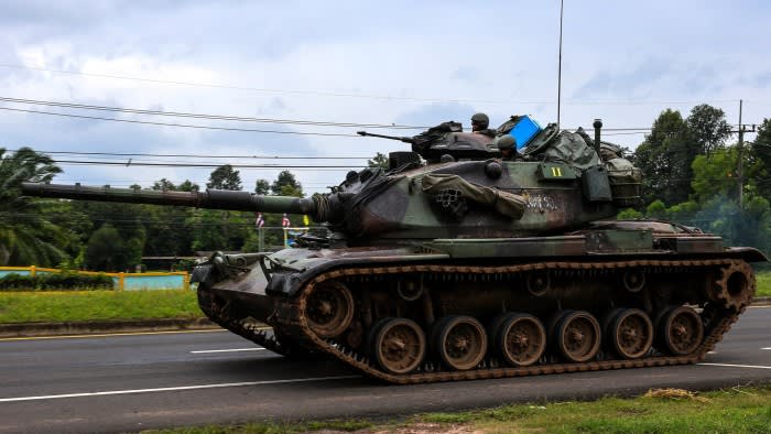 A tank drives on a road toward Thailand-Cambodia’s border