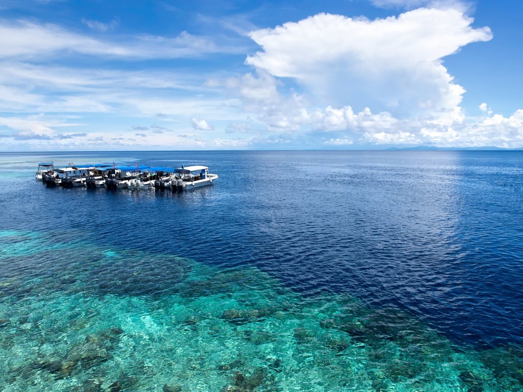 Boats at a dive site off Sipadan, an island over which Malaysia and Indonesia once had rival claims. Photo: Shutterstock