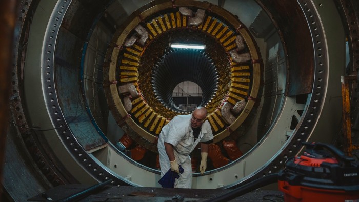 An employee works on a generator at a GE Vernova facility in New York