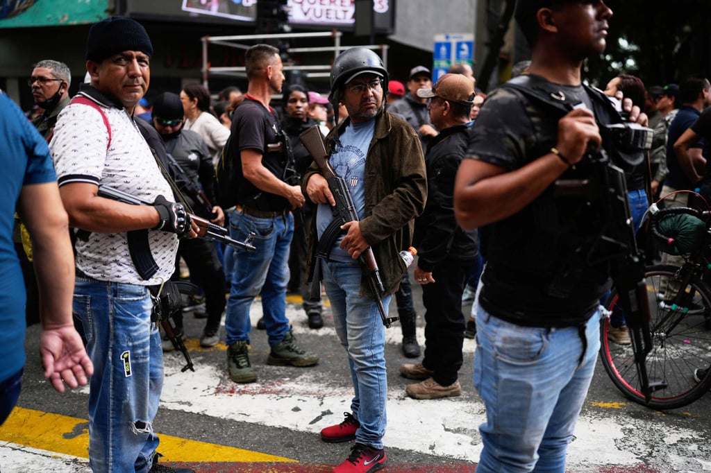 Pro-government, armed civilians at a protest in Caracas, Venezuela, on Sunday. Photo: AP