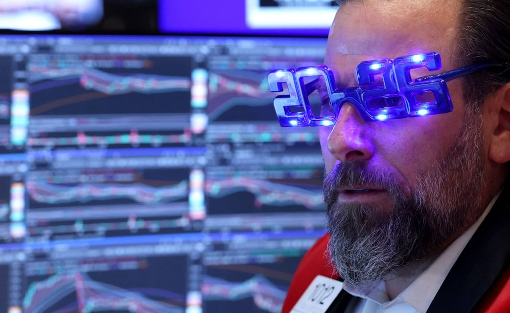 A trader wearing “2026” glasses works on the floor of the New York Stock Exchange on December 31. Photo: AFP