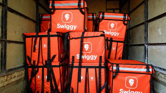 Swiggy delivery bags are stored inside a truck in Mumbai, India