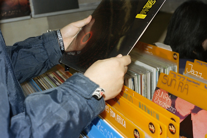 DJ Ma holds up a record at Fruityshop Records in Shanghai