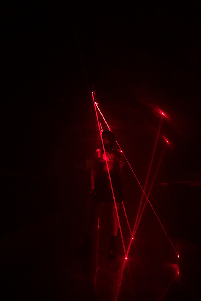 Red strobe lights dance across the floor at underground club The Shelter in Shanghai, 2016