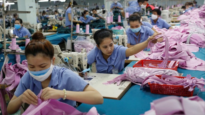Labourers work at a garment assembly line of a Thanh Cong factory in Ho Chi Minh City