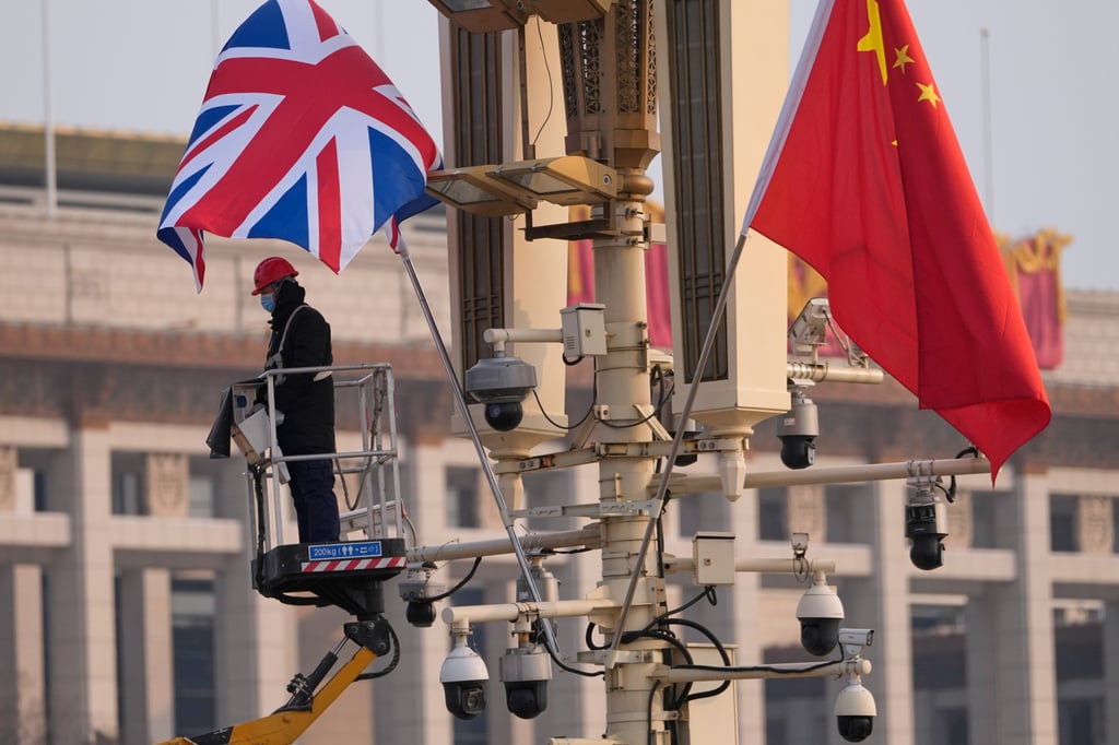 A worker sets up a British national flag next to the Chinese national flag ahead of the visit of UK Prime Minister Keir Starmer in Beijing on Wednesday. Photo: AP